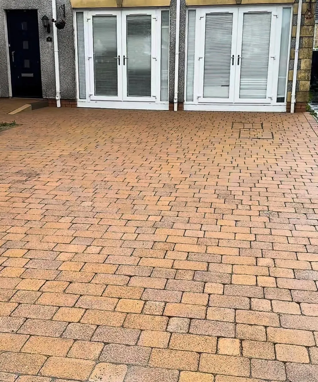 The same block paving driveway after cleaning, warm-coloured and clear of weeds
